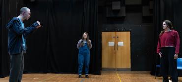 Three cast members in rehearsals for Mosquitoes