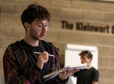 A student holding a notebook